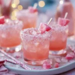 Tray of Pink Starburst cocktails with sugared rims and candy garnishes.